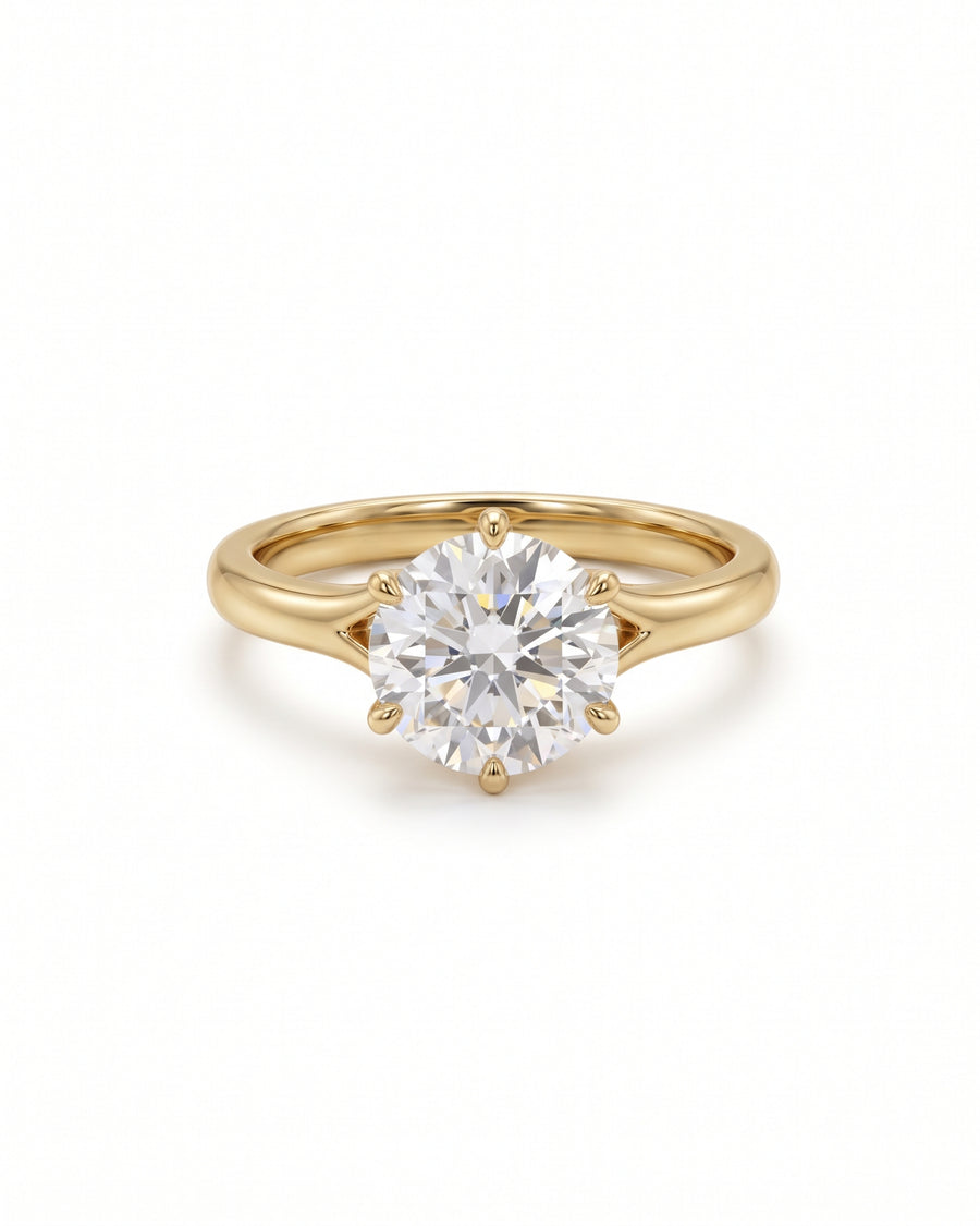 Round cut diamond engagement ring in 18ct yellow gold with a six-prong tulip claw setting.