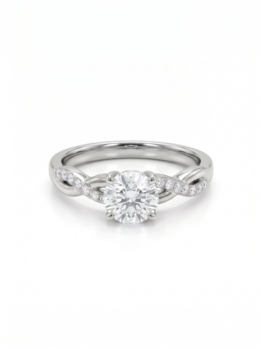 Platinum engagement ring with a round cut center diamond and a twisted band featuring pavé set diamonds.