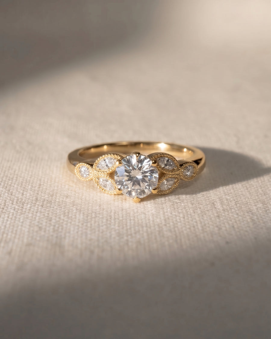 18ct yellow gold vintage engagement ring with a round lab grown diamond and marquise side stones.