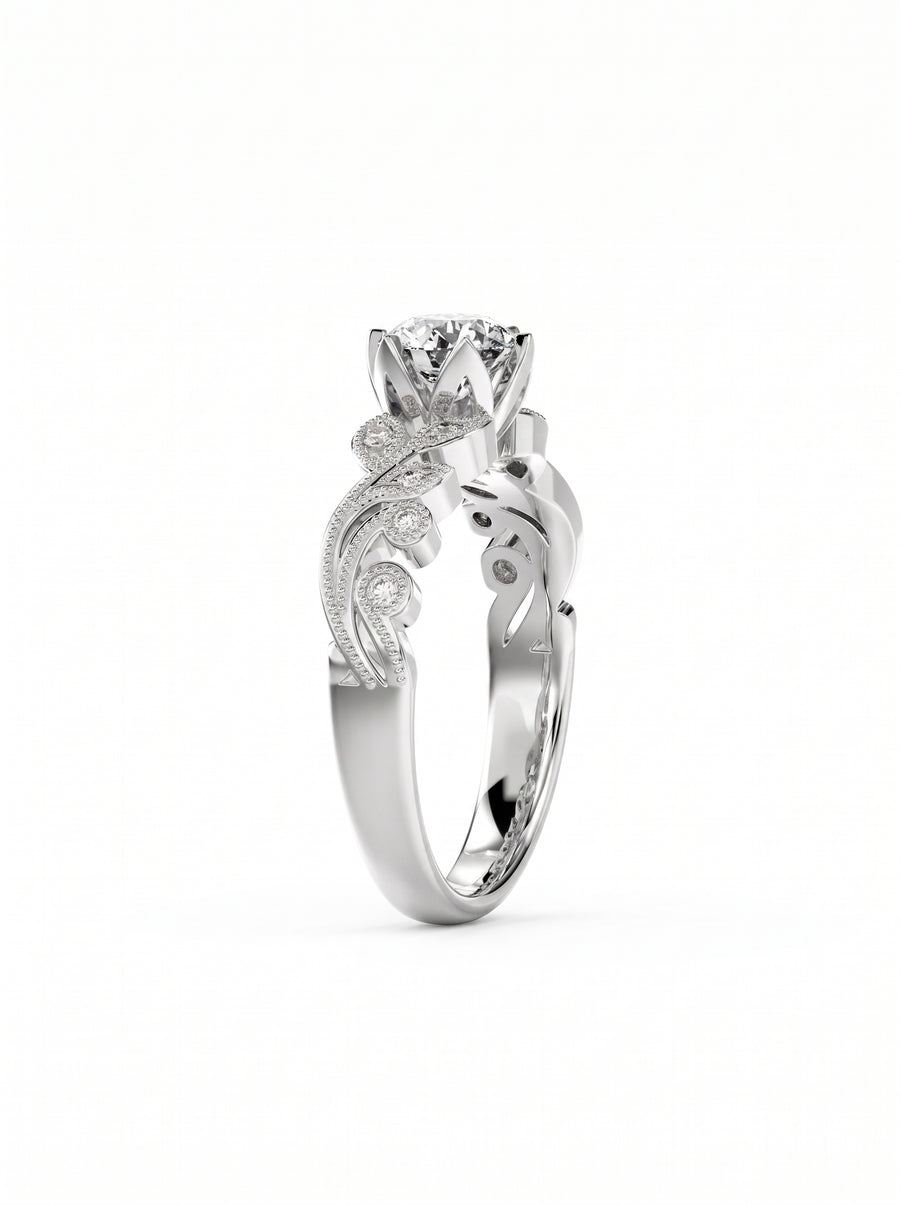 Round cut diamond engagement ring in silver with intricate floral filigree and small accent stones.