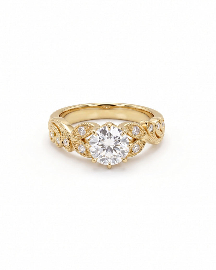 Round cut diamond engagement ring in 18ct yellow gold with vintage-inspired leaf filigree and side stones.