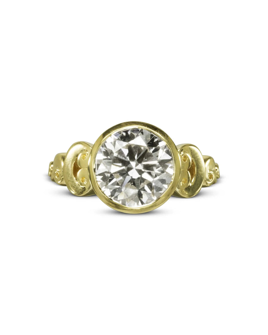Gold rub over diamond engagement ring with ornate band.