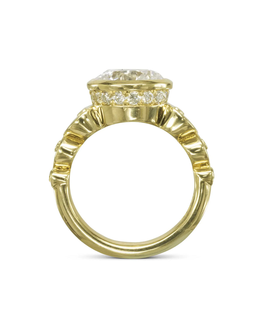 Gold rub over diamond engagement ring with pavé accents.