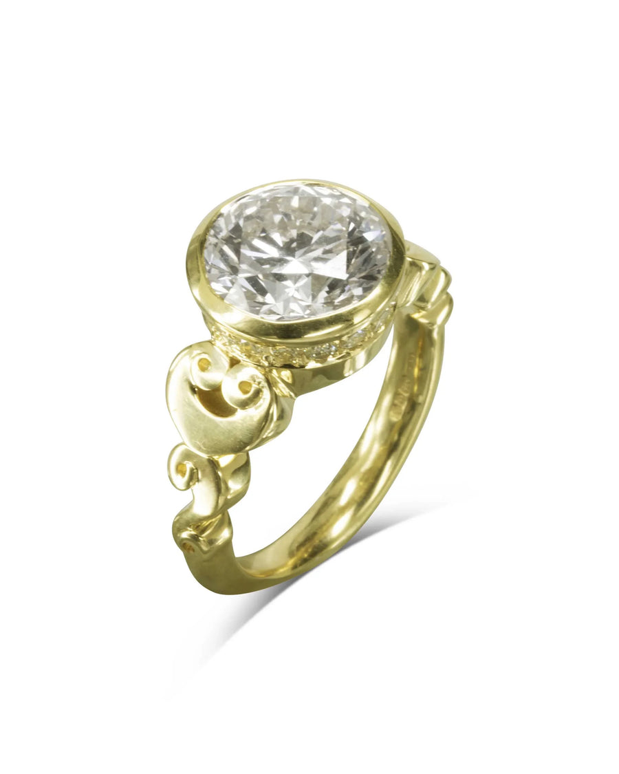 Gold rub over diamond engagement ring with decorative scrollwork.