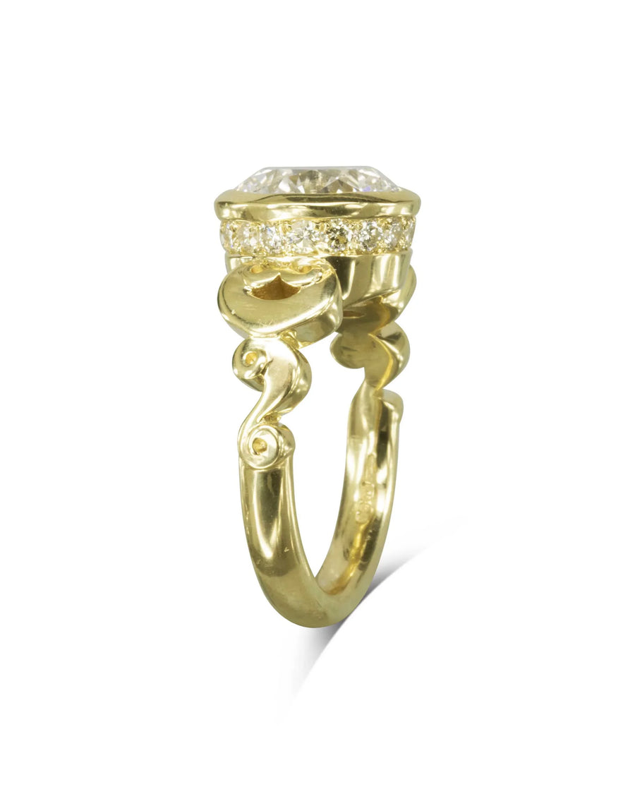 Yellow gold rub over diamond engagement ring with scrollwork.