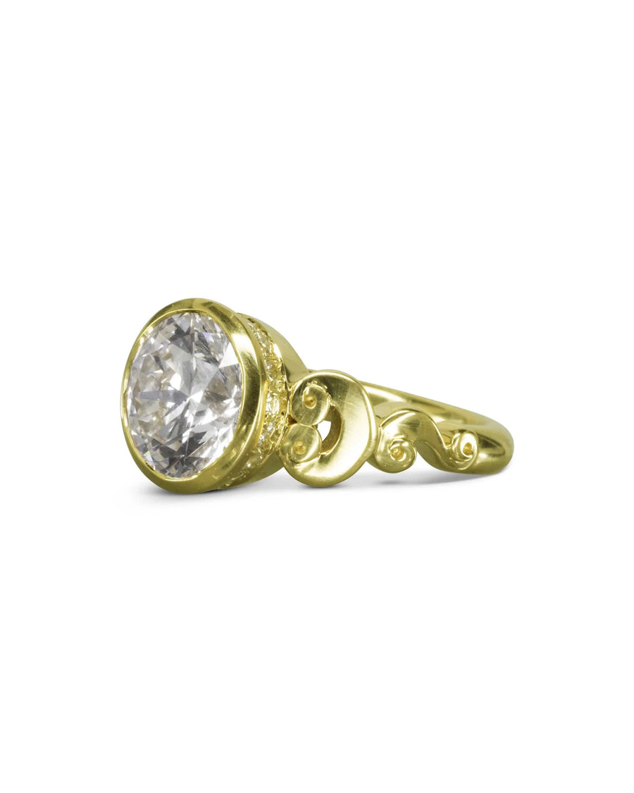 Gold rub over diamond engagement ring with decorative scrollwork.