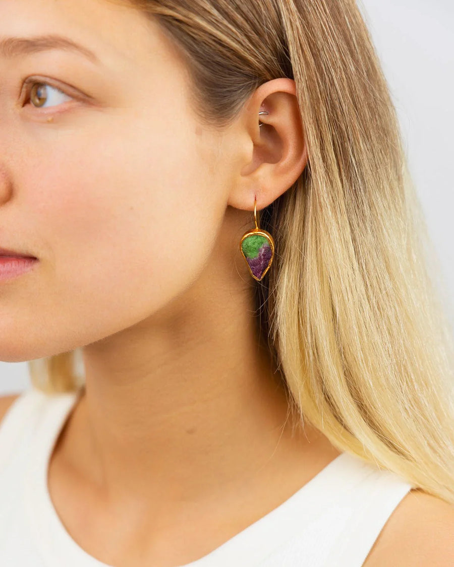 Woman wearing a handmade ruby zoisite drop earring with gold setting