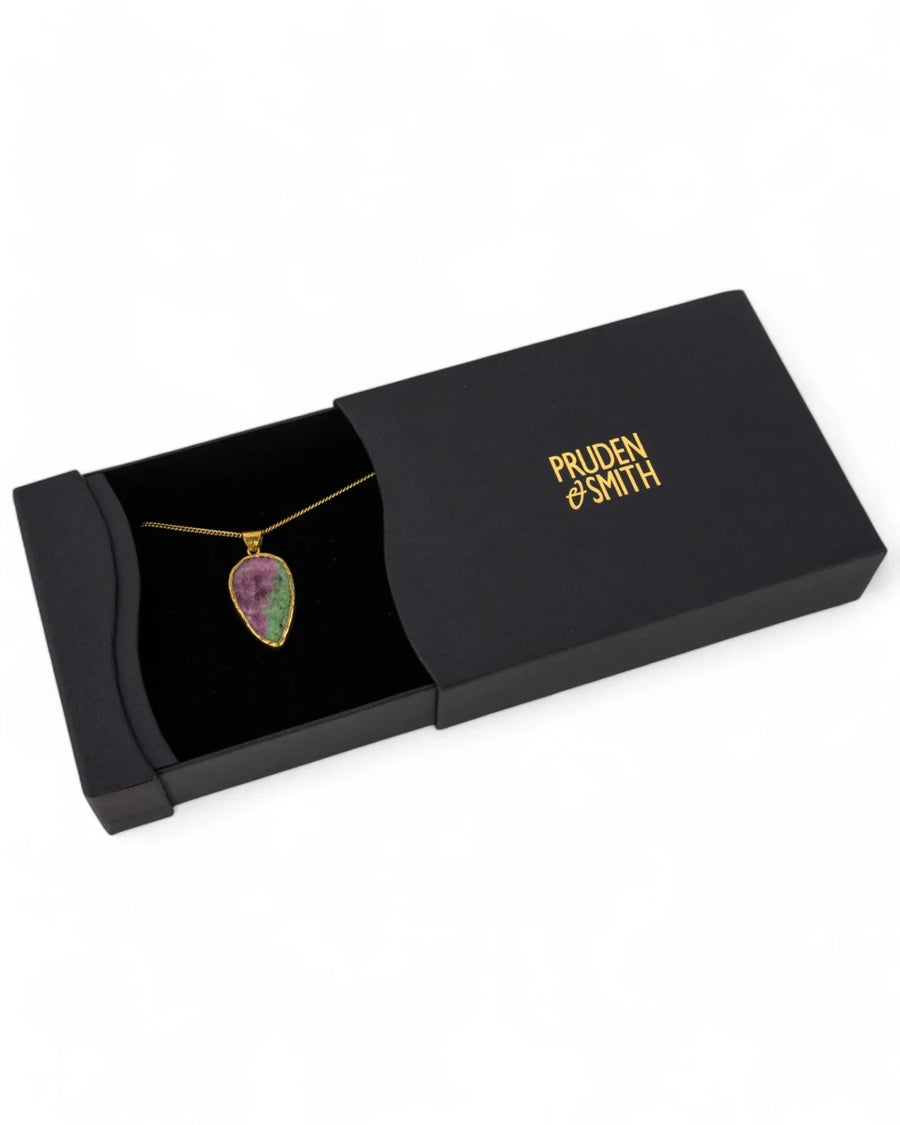 Gold ruby zoisite pendant necklace with chain in gift box on white background