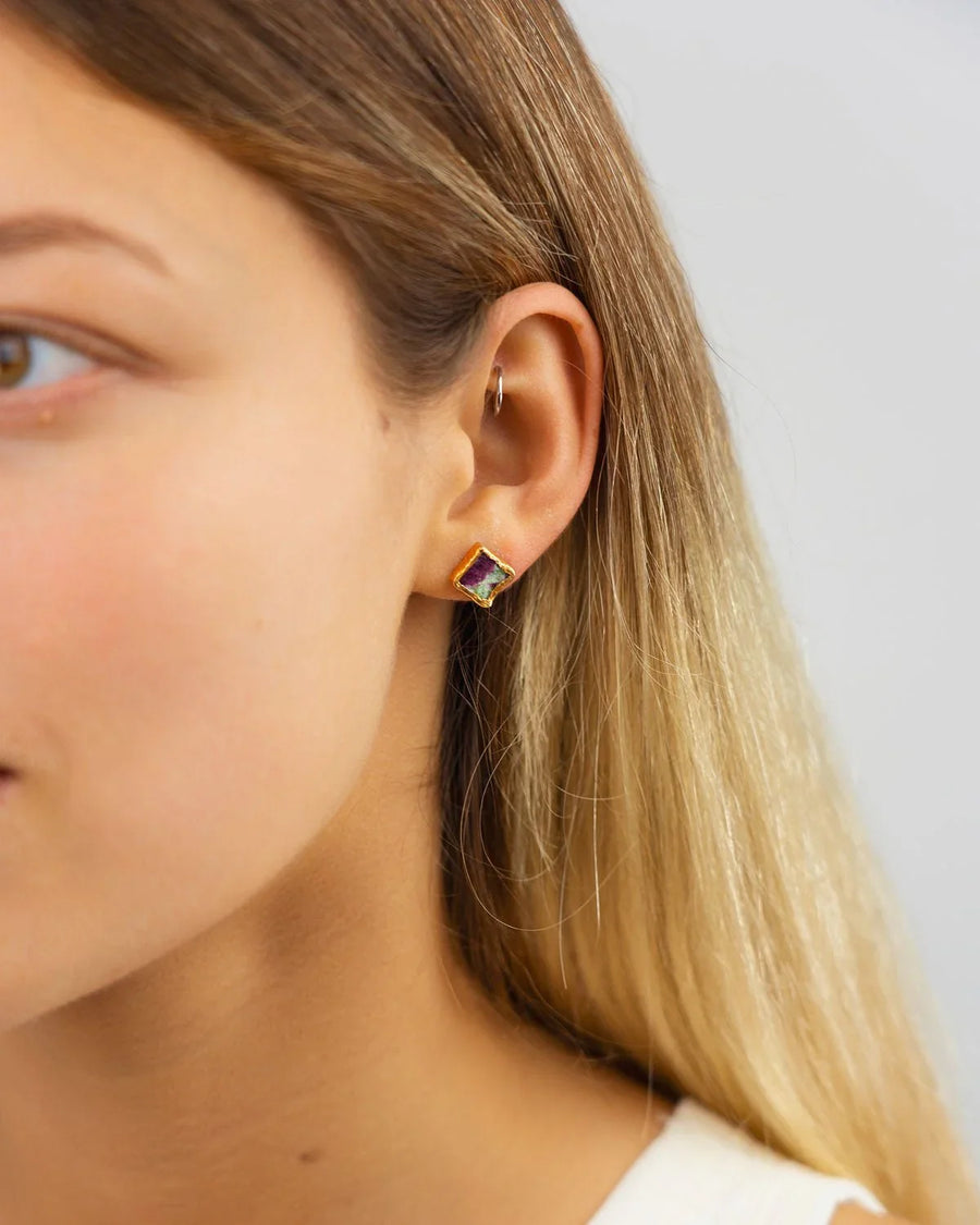 Square ruby zoisite stud earring with gold setting on ear