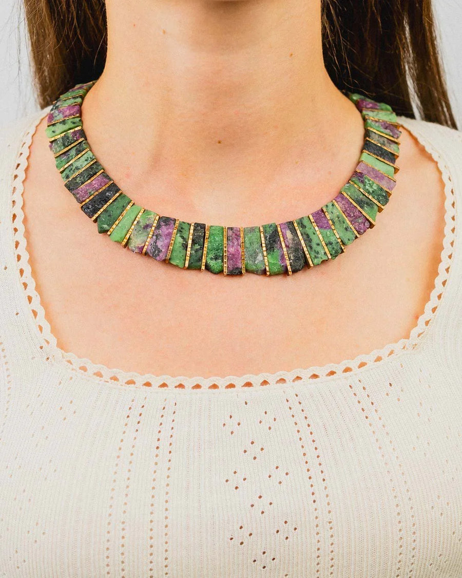 Chunky ruby zoisite necklace with gold accents on a woman wearing a cream knit top
