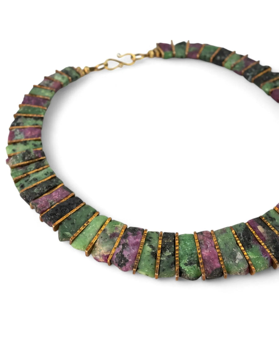 Ruby zoisite necklace with rectangular gemstone tabs and gold spacers on white background