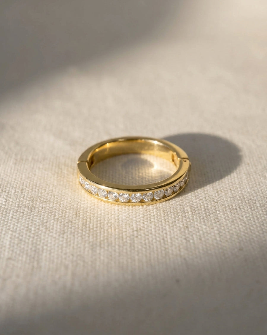 Gold channel set diamond hinged eternity ring.
