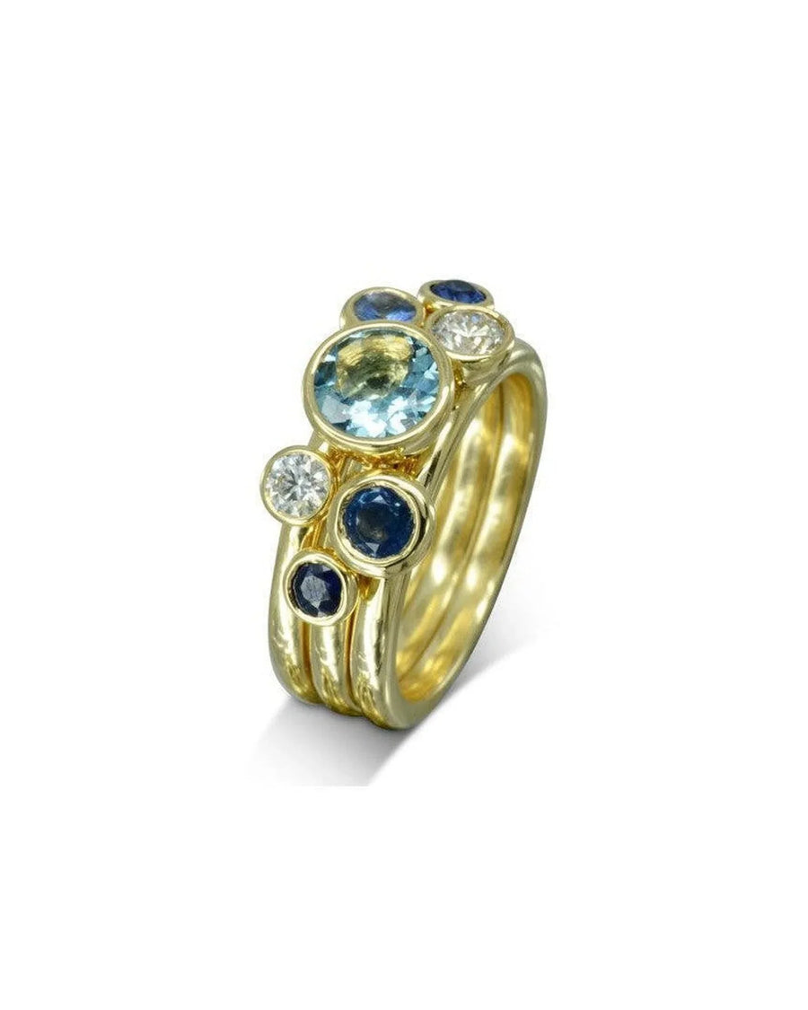 9ct yellow gold stacking rings with sapphire, aquamarine, and diamond gemstones.
