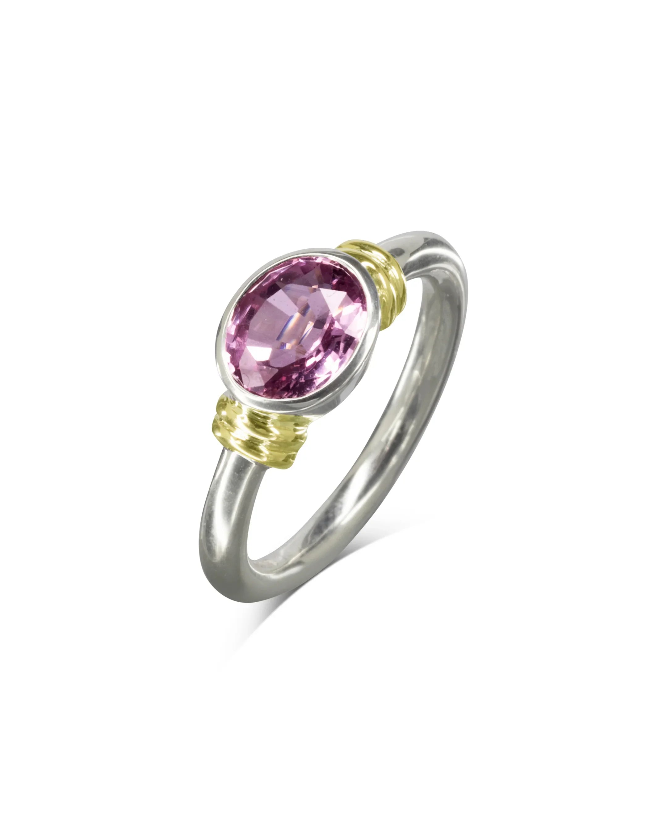 Handmade silver ring with oval pink sapphire and gold double shoulder detailing