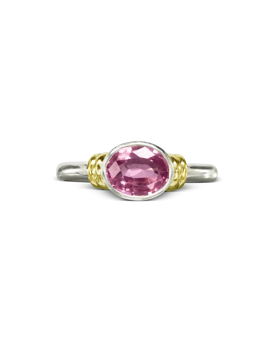 Oval pink sapphire ring with yellow gold accents on a silver band, luxury handmade jewellery