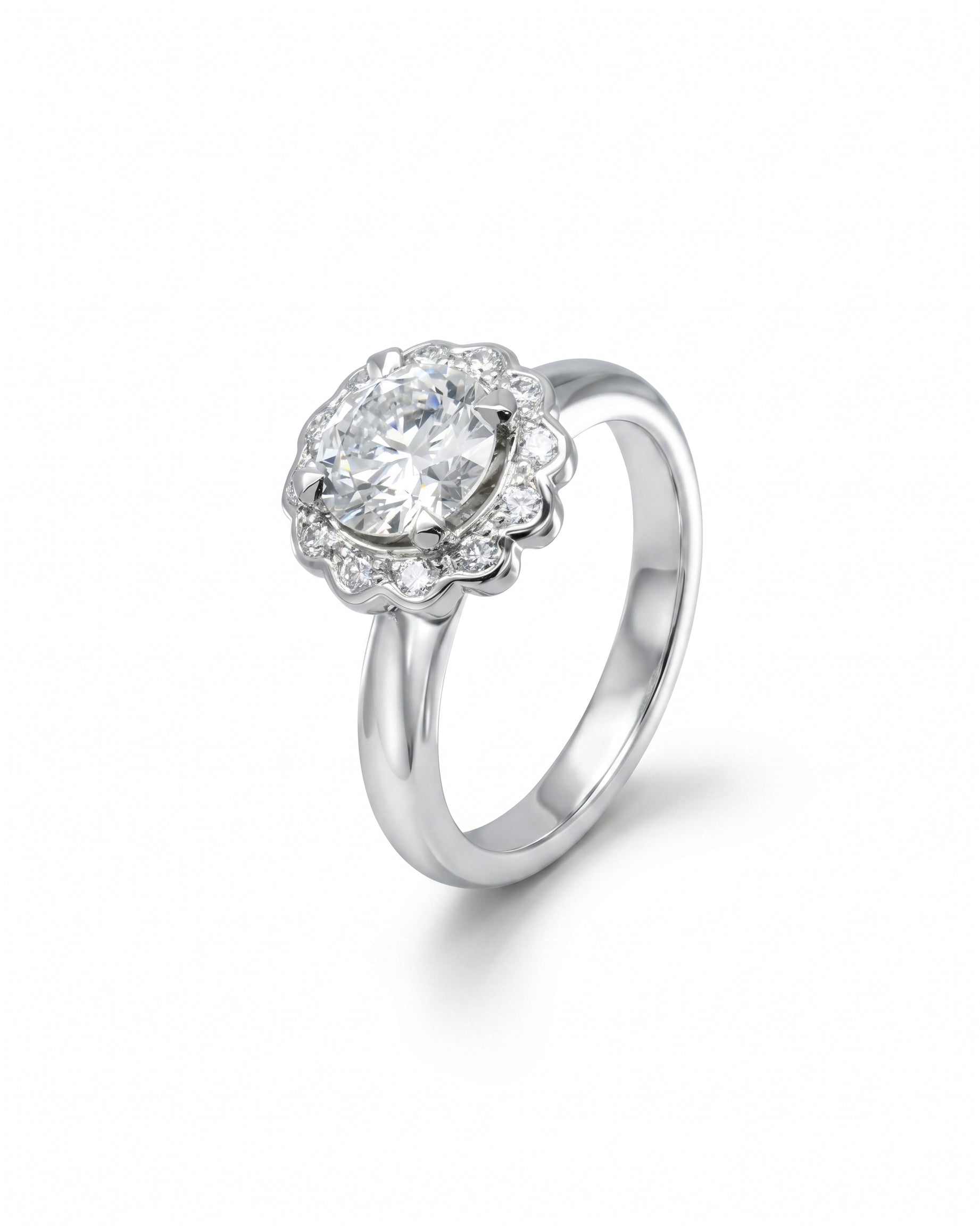 Silver scalloped diamond cluster engagement ring with a large center stone.