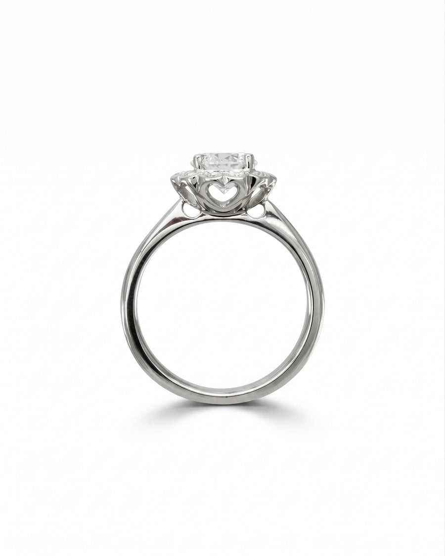 White gold scalloped diamond cluster engagement ring with heart details.