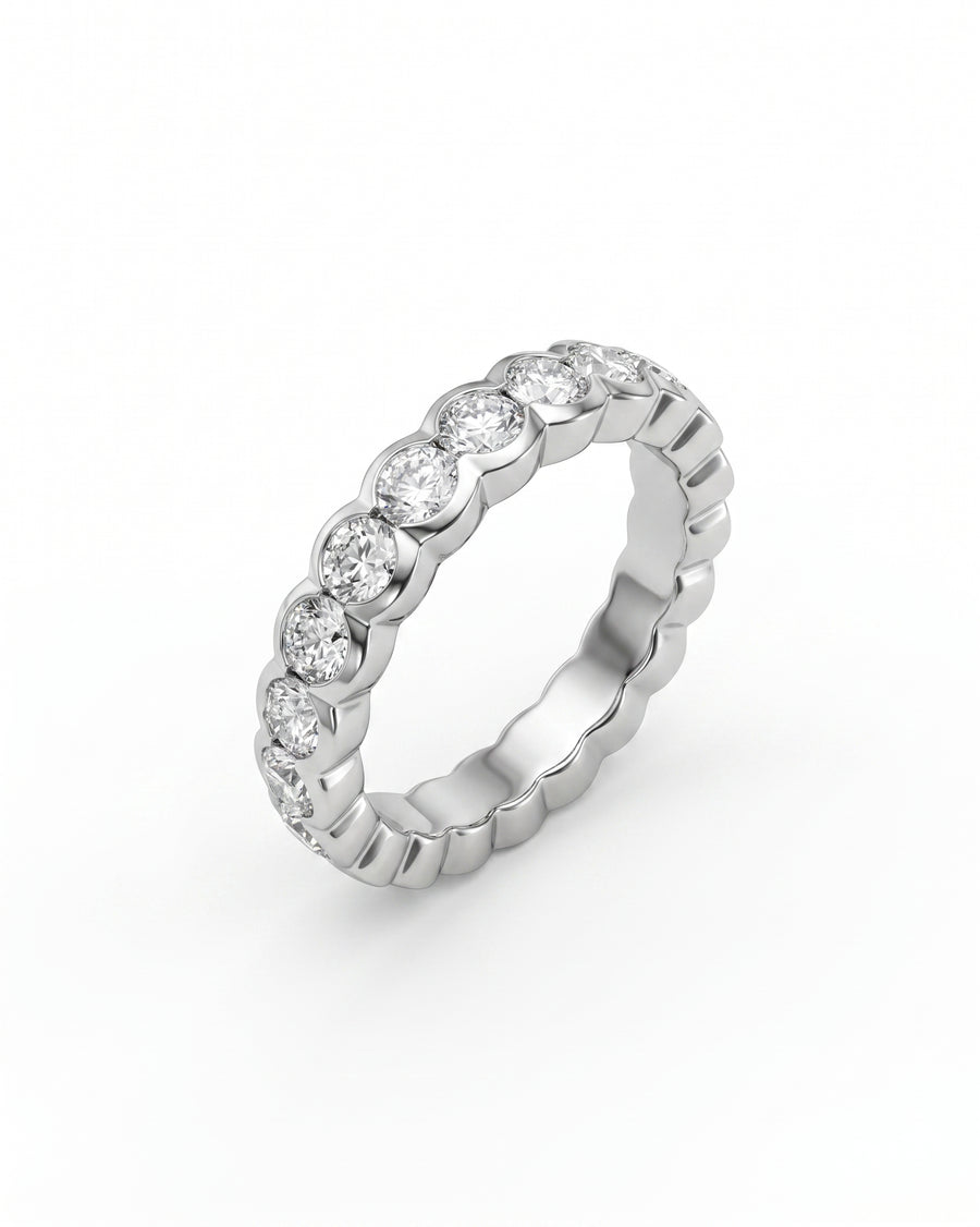 Silver scalloped diamond eternity ring with round brilliant diamonds.
