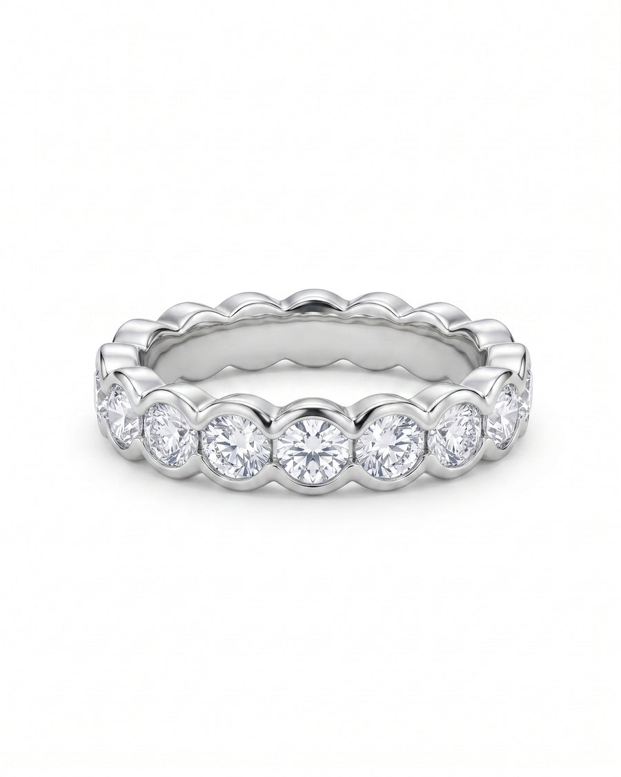 Silver scalloped eternity ring with round diamonds.