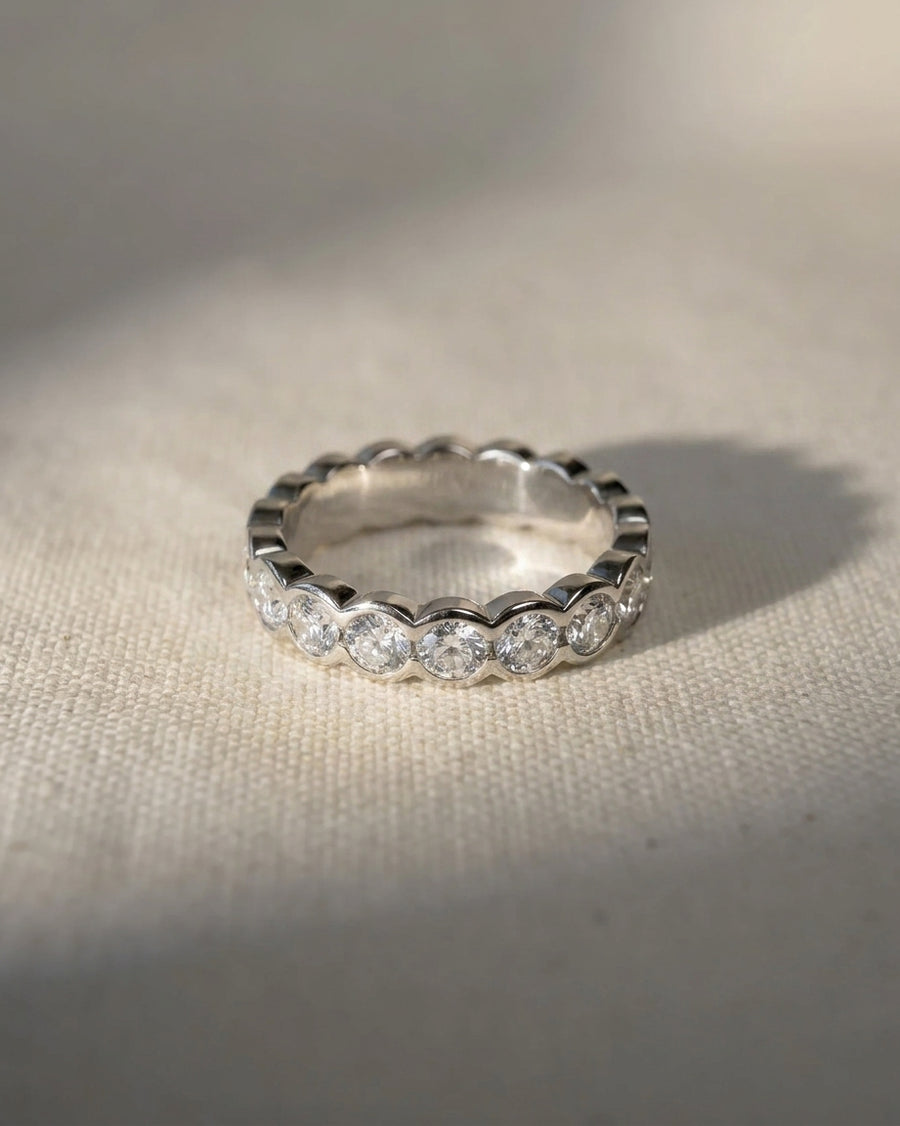 Platinum scalloped diamond half eternity ring.