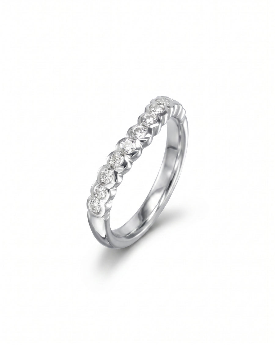 White gold scalloped diamond wedding band with nine round diamonds.