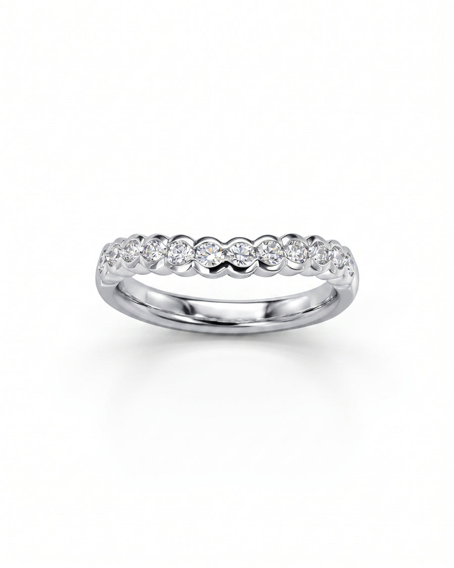 White gold scalloped diamond wedding band with round brilliant diamonds.