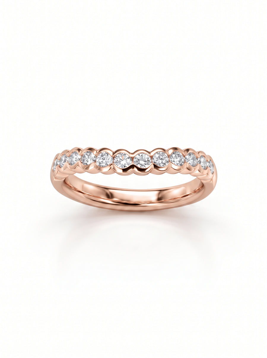 Rose gold wedding band featuring a scalloped design set with round brilliant cut diamonds.