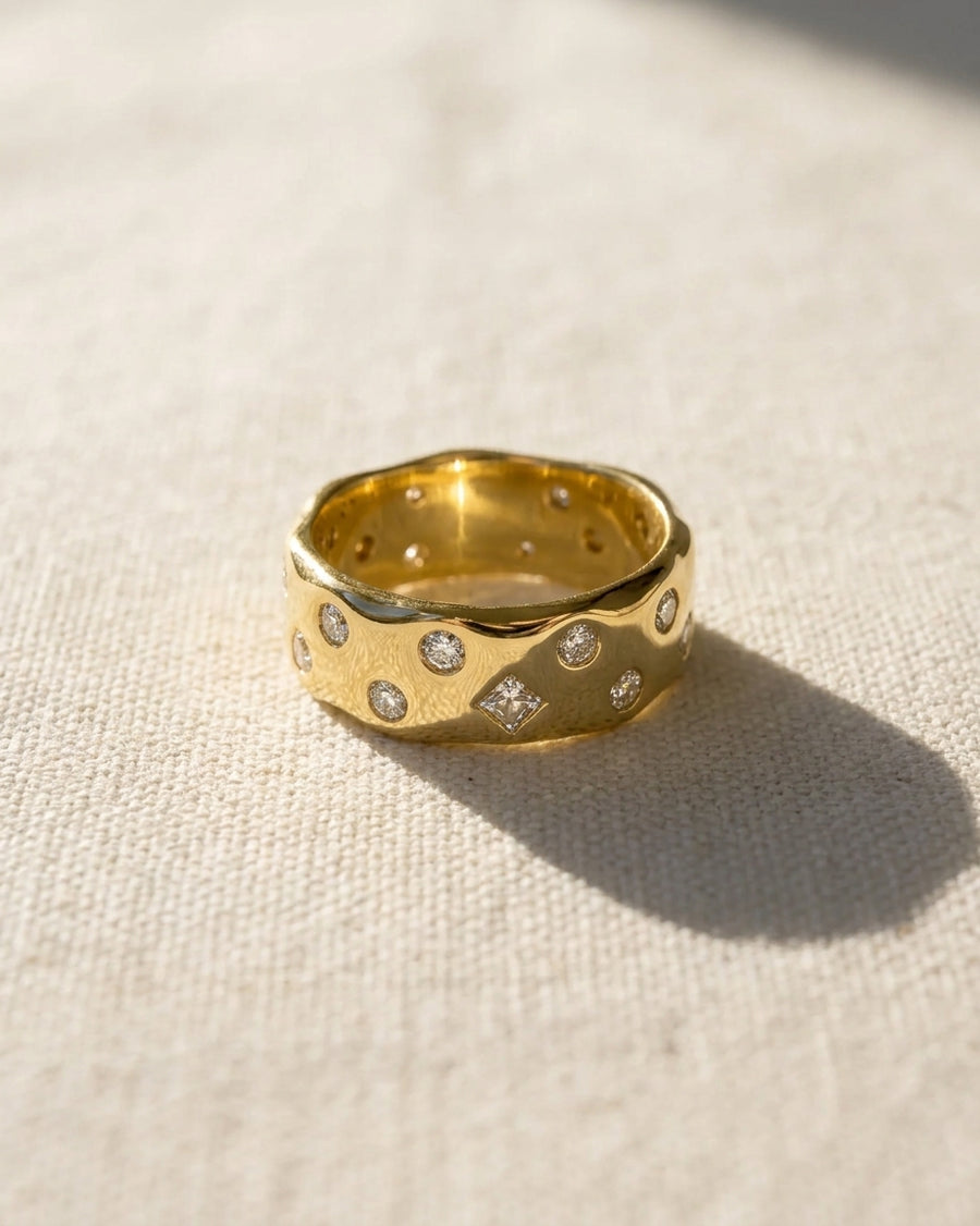 18ct yellow gold ring with scattered round and square diamonds.