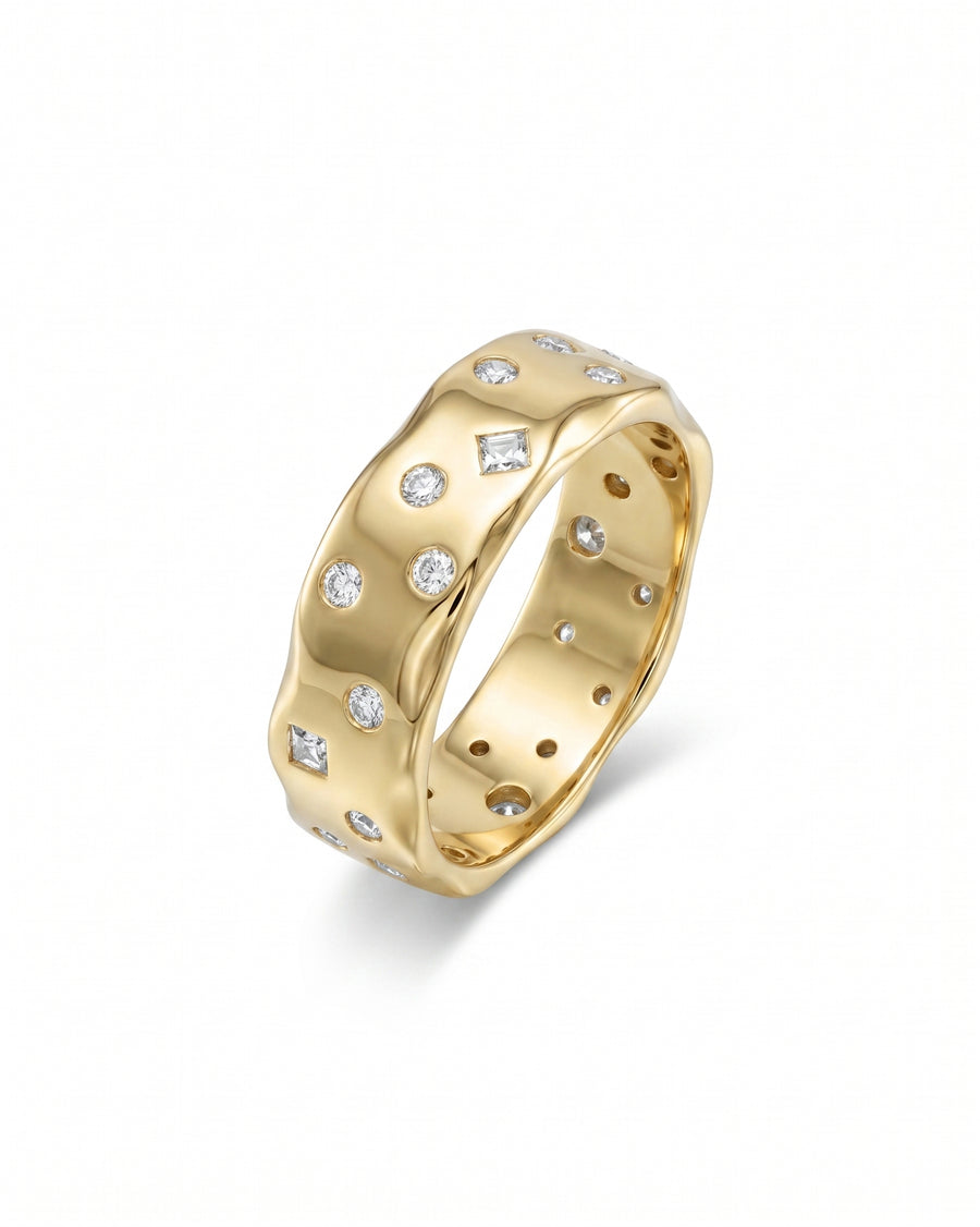 Yellow gold ring with scattered round and baguette diamonds.