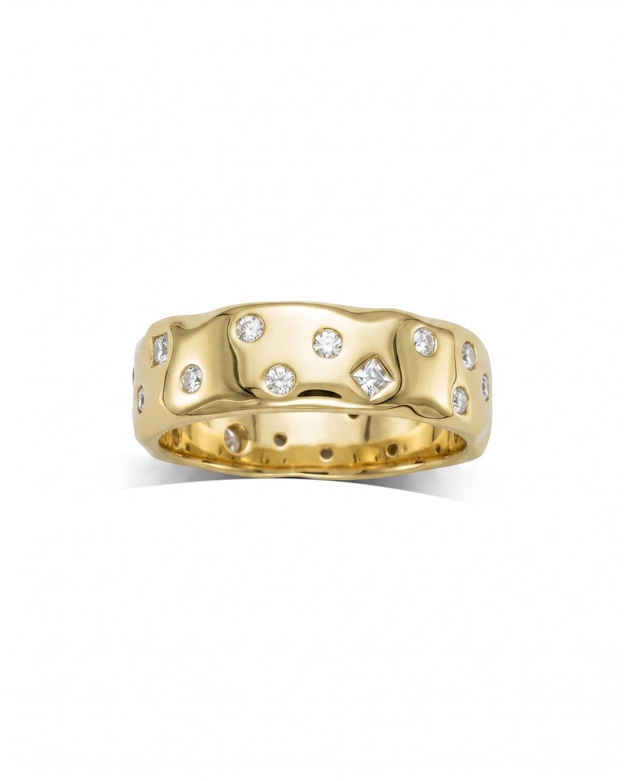 Yellow gold ring with scattered round and square diamonds.
