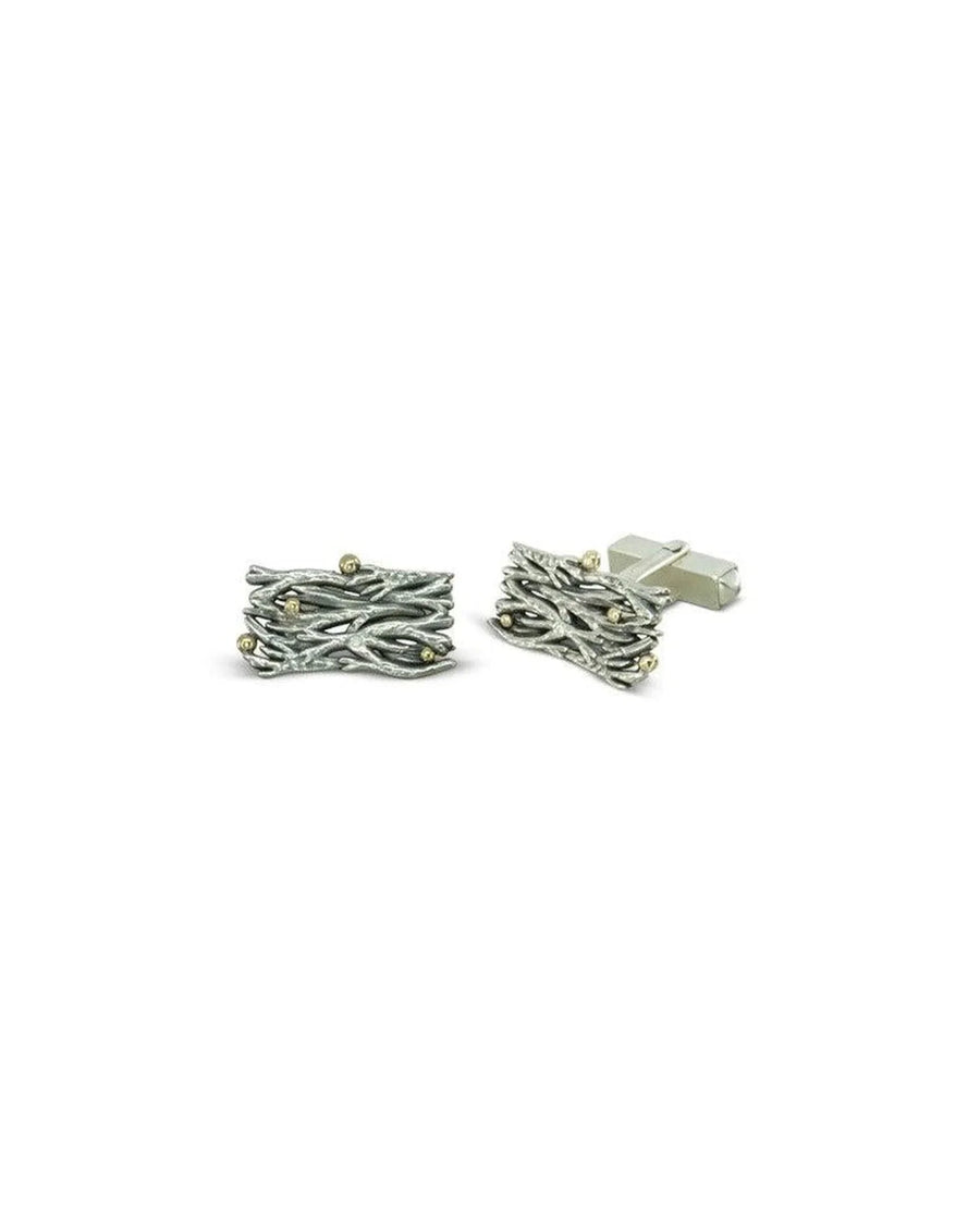 Seaweed-inspired silver cufflinks with yellow gold accents on a white background