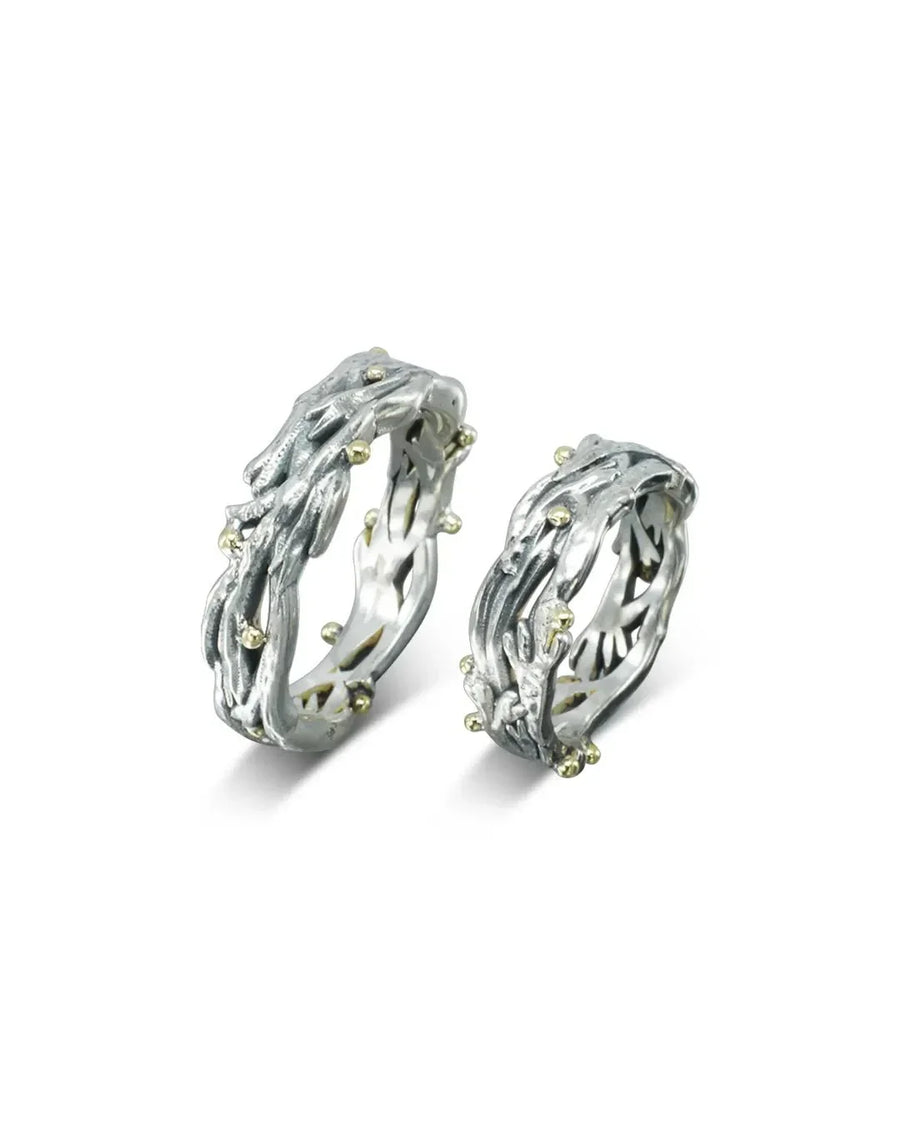 Organic seaweed-inspired rings in white metal with yellow gold accents on a white background