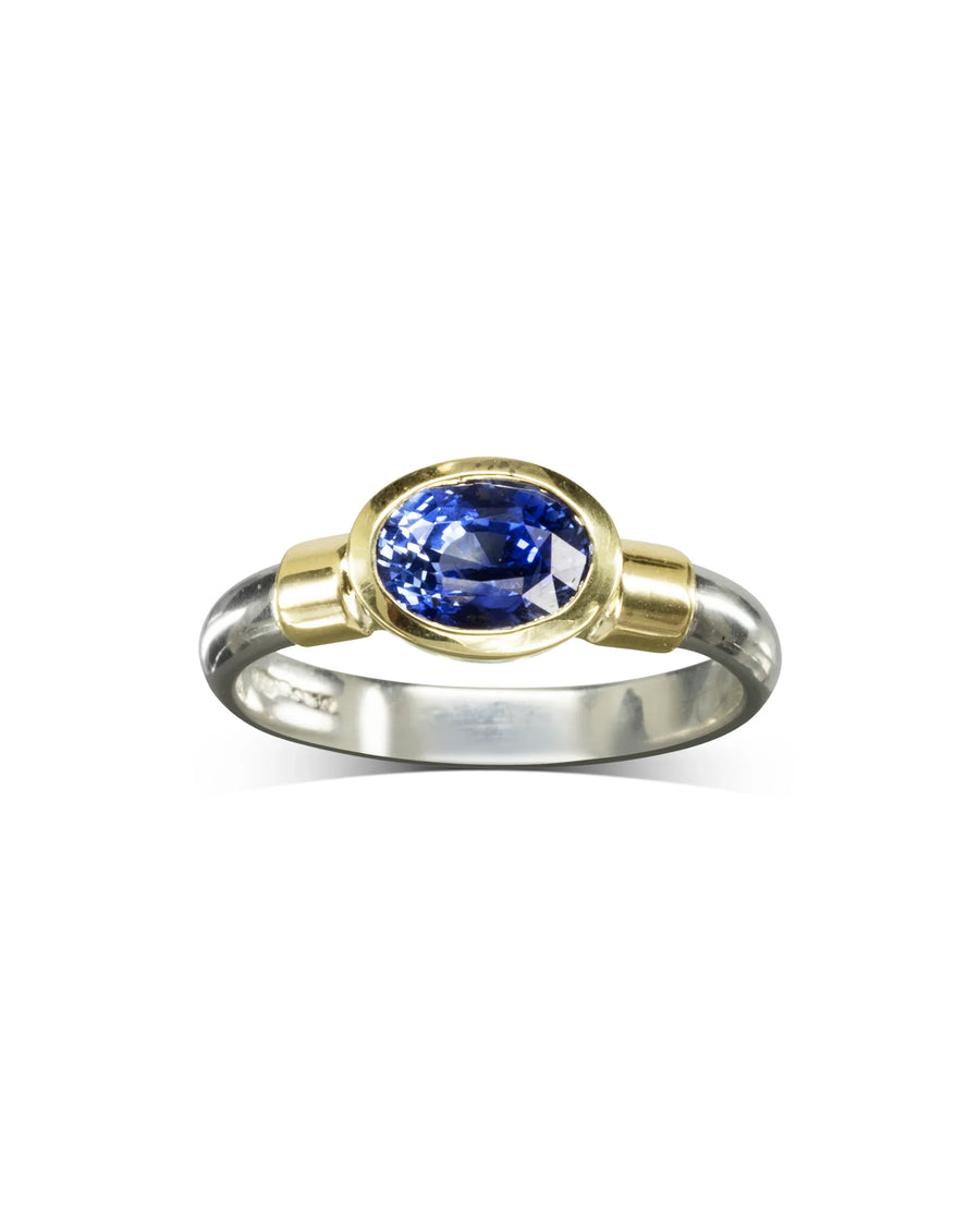 Handmade two-tone ring with oval blue sapphire set in yellow gold on a silver band