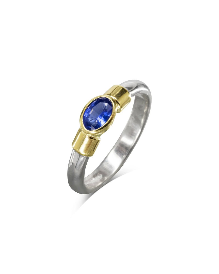 Handmade silver ring with gold setting and oval blue sapphire gemstone