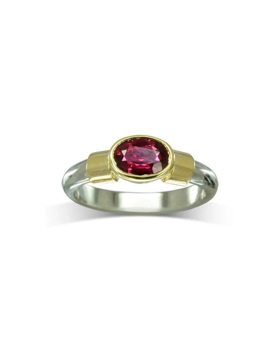 Gold and clear band ring with an oval ruby solitaire.