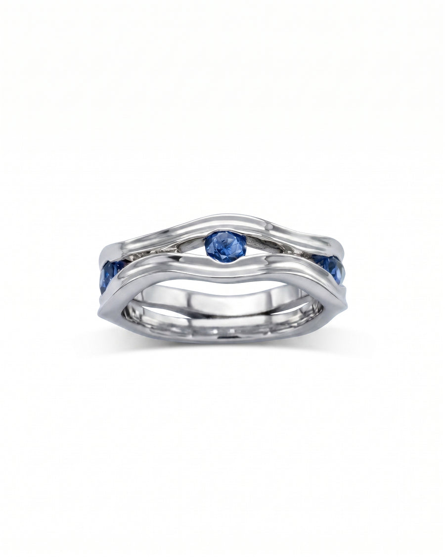 Silver hammered eternity ring with blue birthstones.