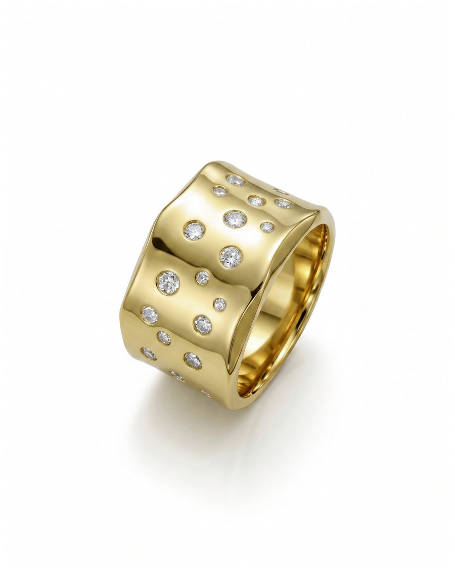 Wide gold ring with hammered, brushed texture and scattered round diamonds.