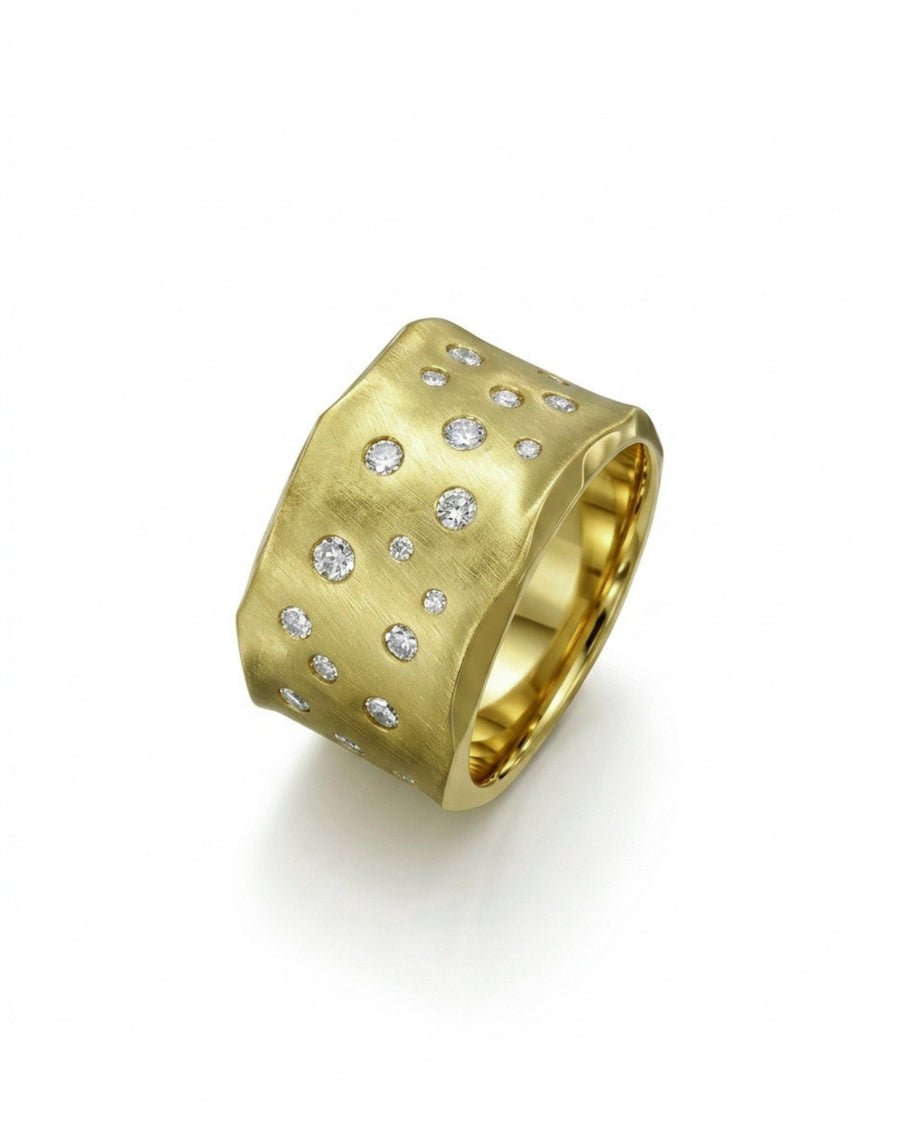 Wide gold ring with hammered, brushed texture and scattered round diamonds.