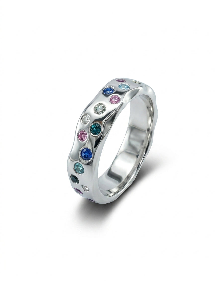 Silver side hammered eternity ring with colorful round gemstones.