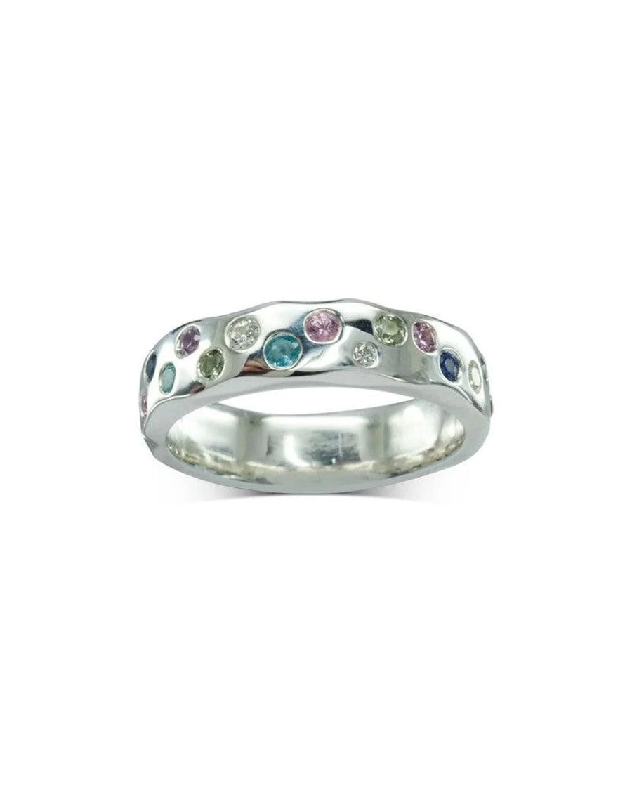 Silver side hammered eternity ring with colorful round gemstones.