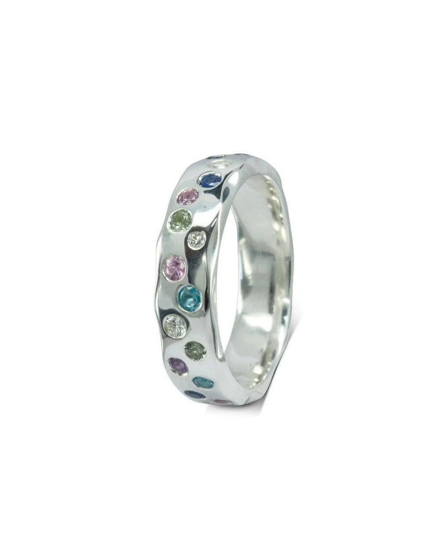 Silver side hammered eternity ring with colorful gemstones.