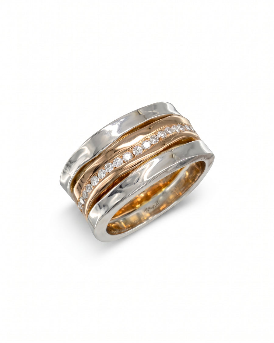 Side hammered platinum and rose gold eternity ring with diamonds.