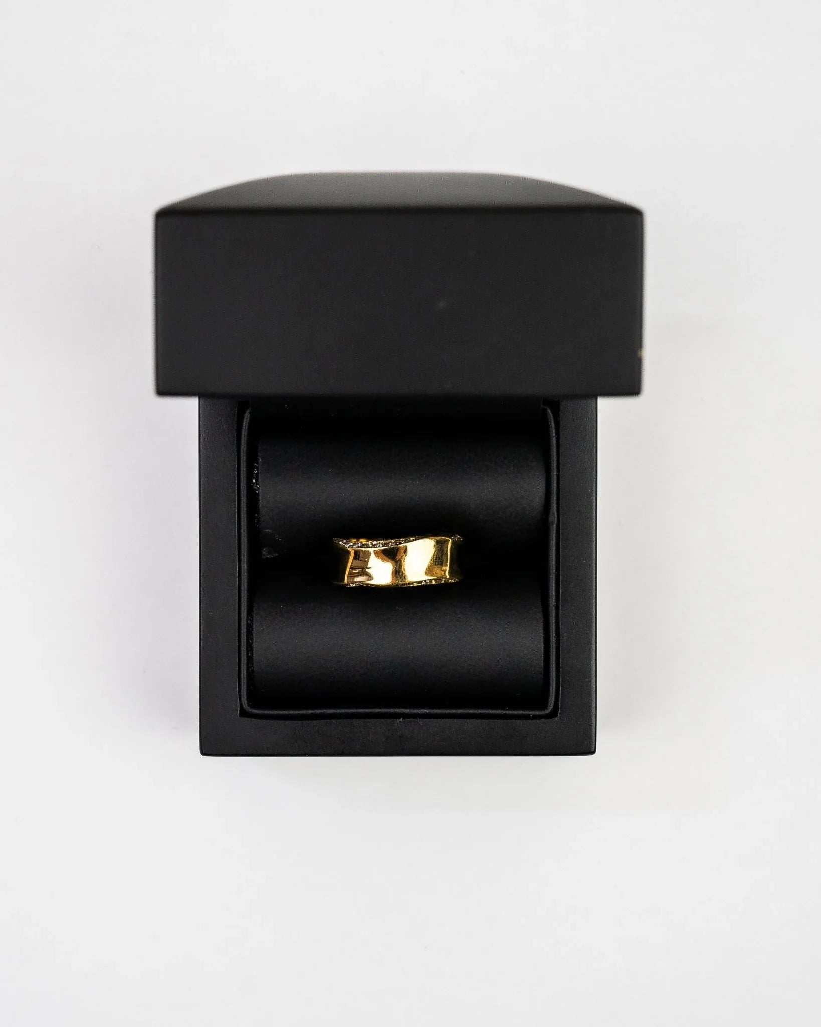 Gold hammered eternity ring with diamond accents in a black ring box