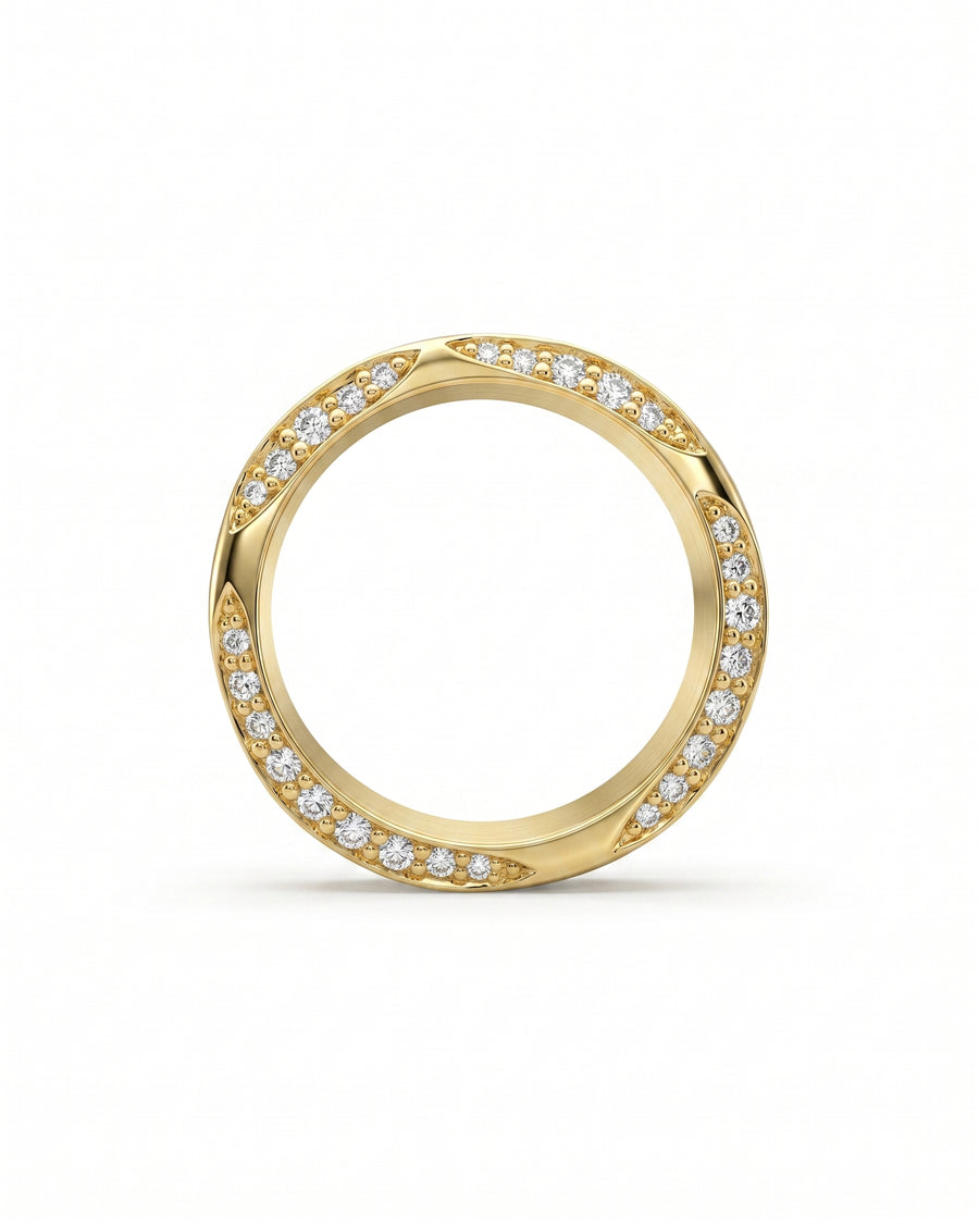 Gold eternity ring with side hammered edge and diamond accents.