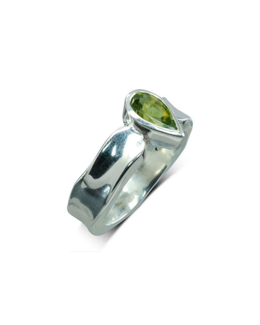 Silver side hammered ring with a pear-shaped green gemstone.