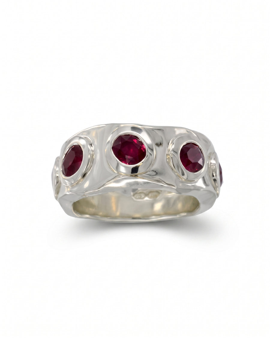 Side hammered 9ct white gold eternity ring with round rubies.