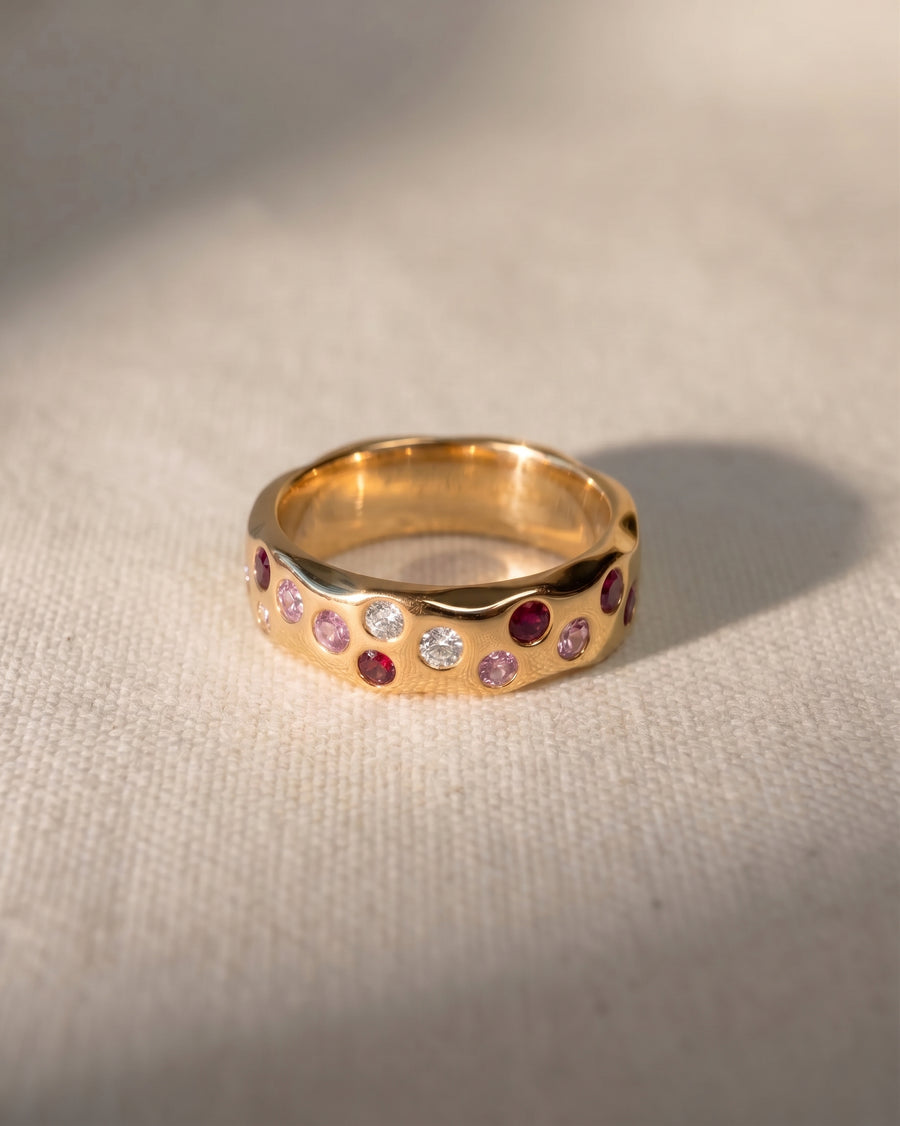 9ct yellow gold eternity ring with blue pink sapphire and diamond gemstones.