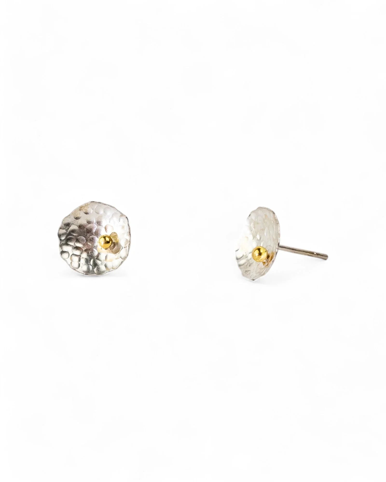 Silver hammered stud earrings with a small gold bead center.