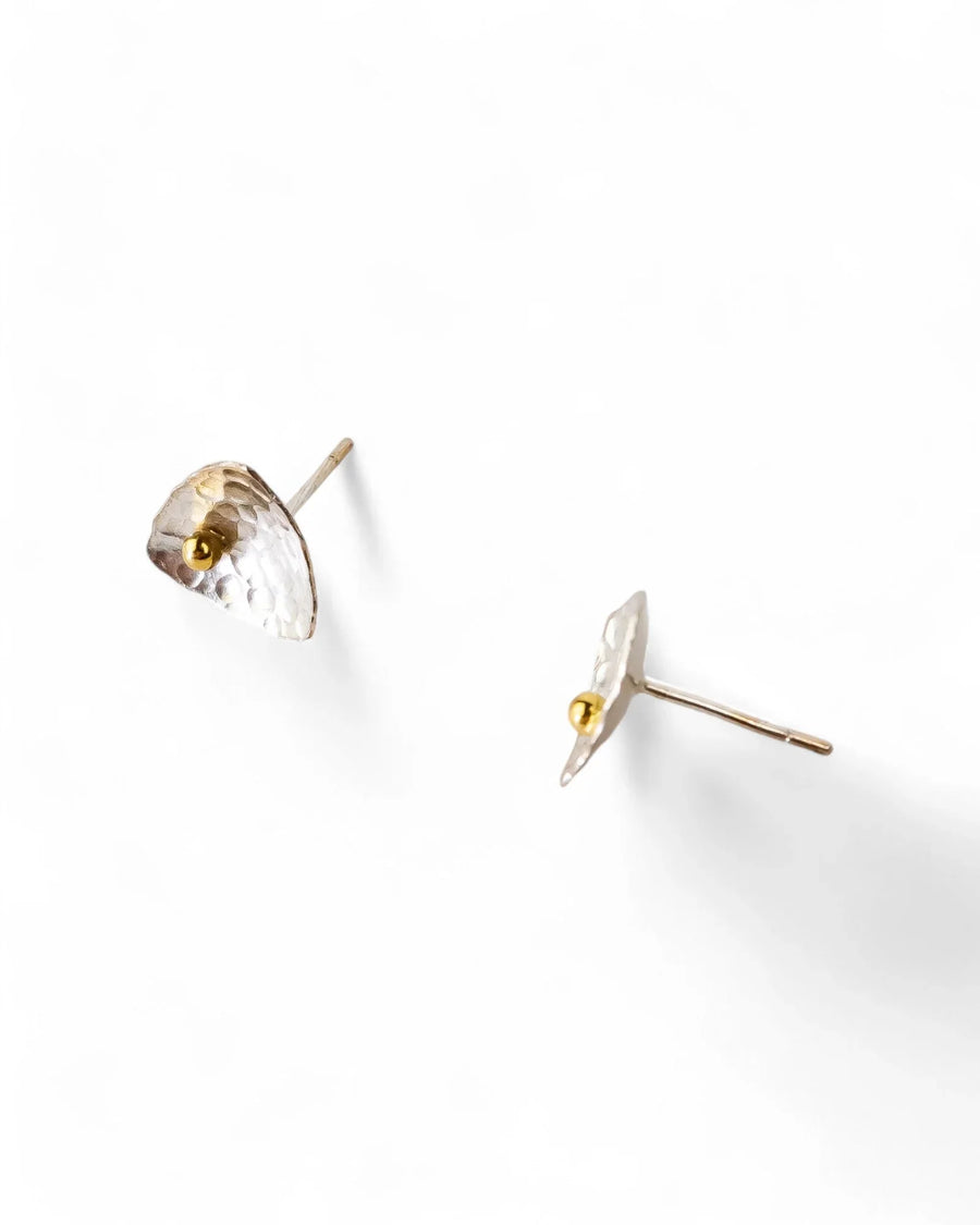 Silver and gold beaded stud earrings with a hammered, organic shape.