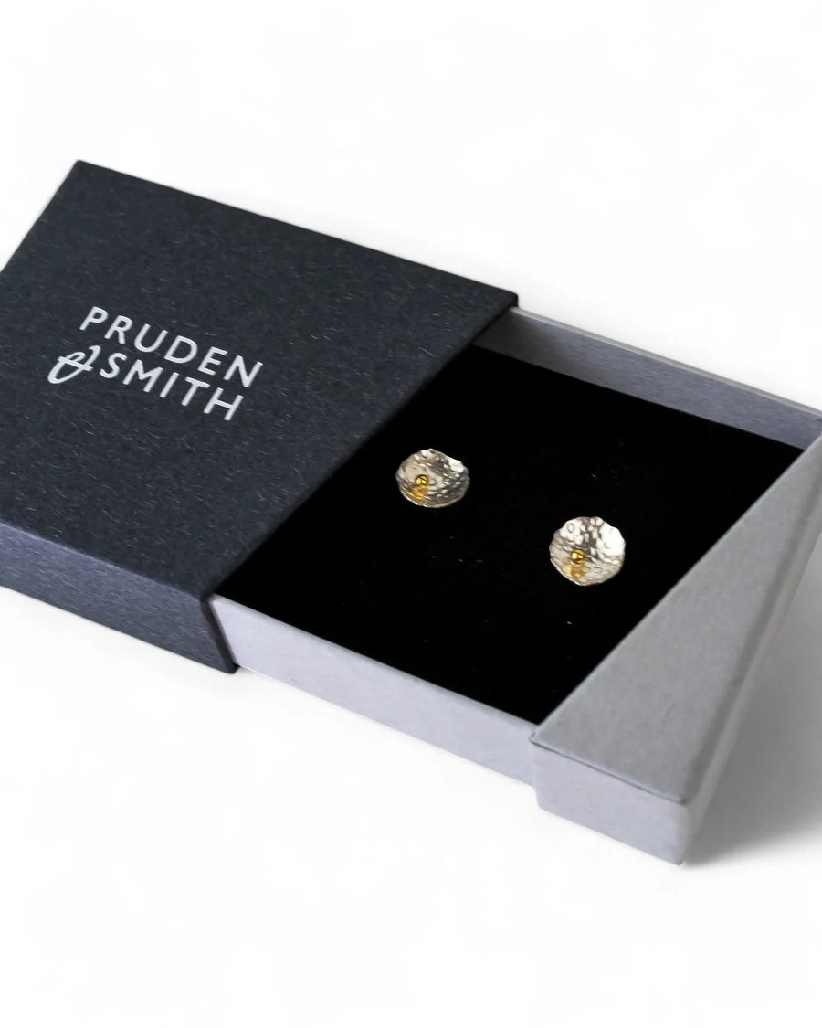 Silver and gold beaded stud earrings in a black gift box.